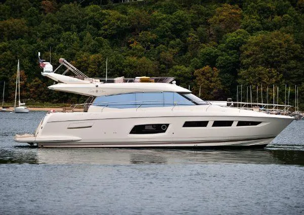 Slide: The Image of Luxury 2014 Prestige 550 yacht cruising on a serene lake. - 4