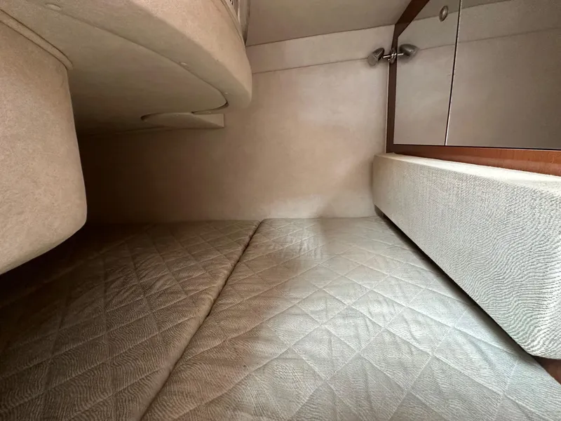 Slide: The Image of Interior cabin of 2008 Sea Ray 280 Sundancer with beige upholstery and storage cabinets. - 17