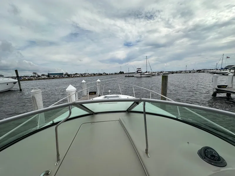 Slide: The Image of Bow view of 2008 Sea Ray 280 Sundancer docked in a marina under cloudy skies. - 19