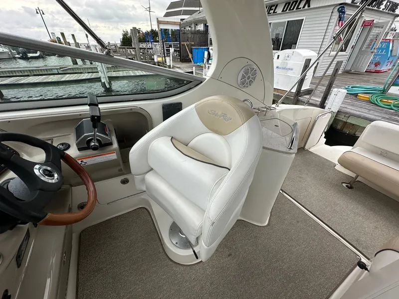 Slide: The Image of 2008 Sea Ray 280 Sundancer cockpit with steering wheel and helm seat at marina. - 7