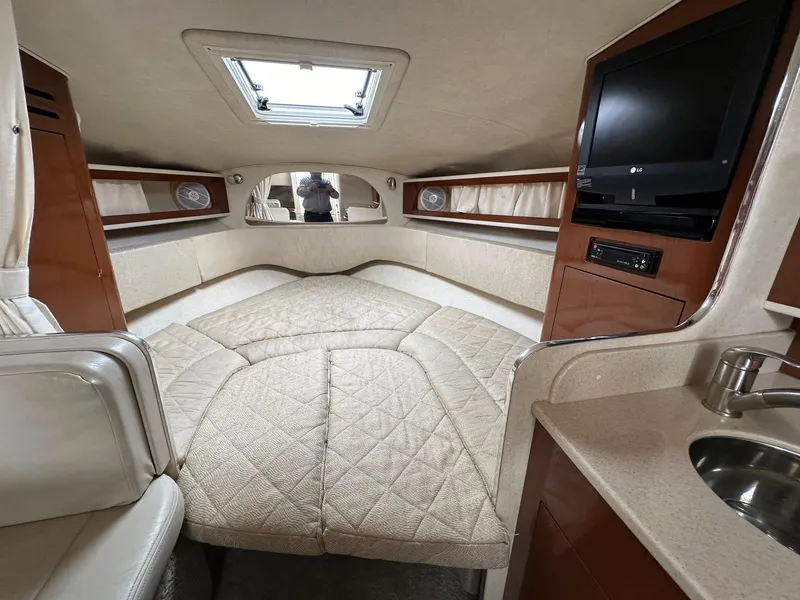 Slide: The Image of Interior of 2008 Sea Ray 280 Sundancer with bed, TV, and skylight. - 9