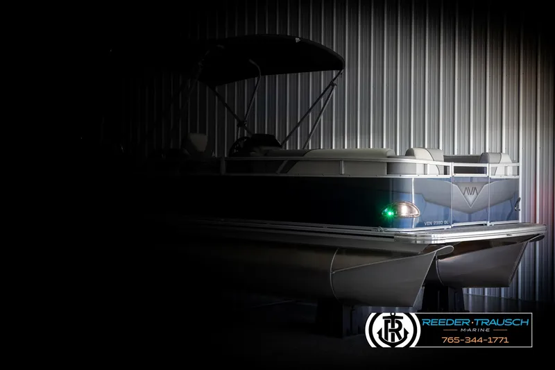Slide: The Image of 2025 Avalon VEN QL pontoon boat in dimly lit storage facility. - 4