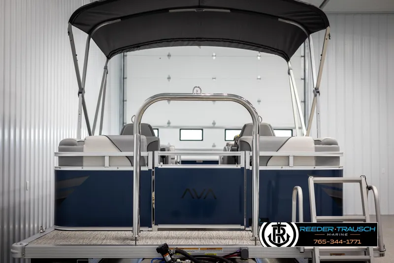 Slide: The Image of 2025 Avalon VEN QL pontoon boat in a showroom with canopy and seating. - 7