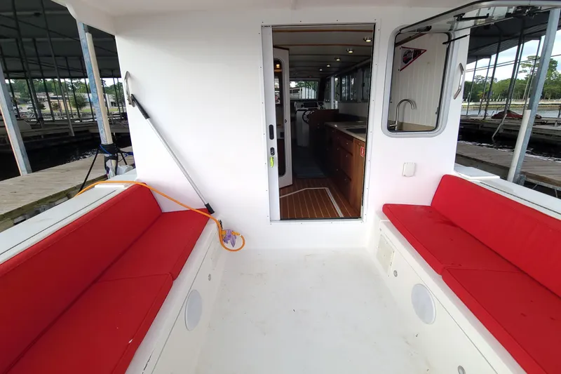 Slide: The Image of Interior view of 2018 Great Harbour TT35 boat with red seating and open cabin door. - 11
