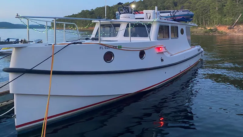 Slide: The Image of 2018 Great Harbour TT35 boat docked on calm water at sunset. - 2