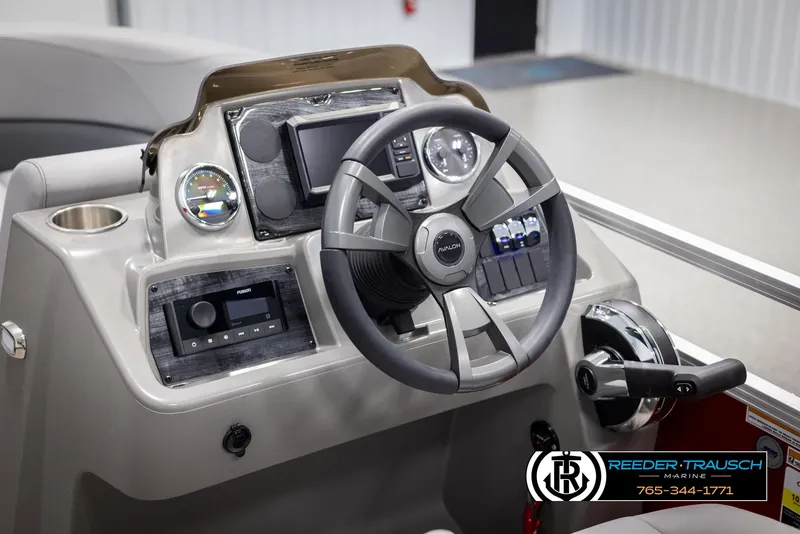 Slide: The Image of 2025 Avalon VLS QL boat dashboard with steering wheel and control panel. - 25