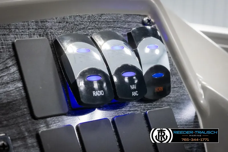 Slide: The Image of Close-up of 2025 Avalon VLS QL dashboard switches for radio, navigation, and horn. - 31