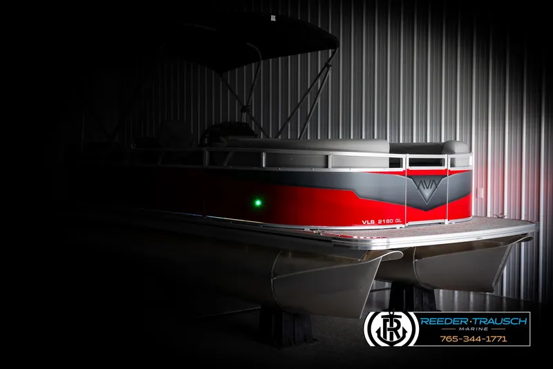 Slide: The Image of 2025 Avalon VLS QL pontoon boat in a dimly lit showroom. - 4