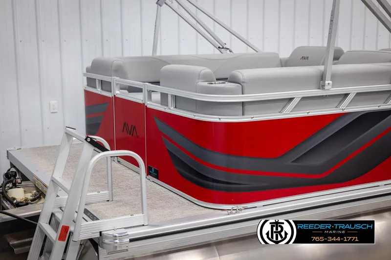 Slide: The Image of 2025 Avalon VLS QL pontoon boat, red and gray design, docked indoors. - 42