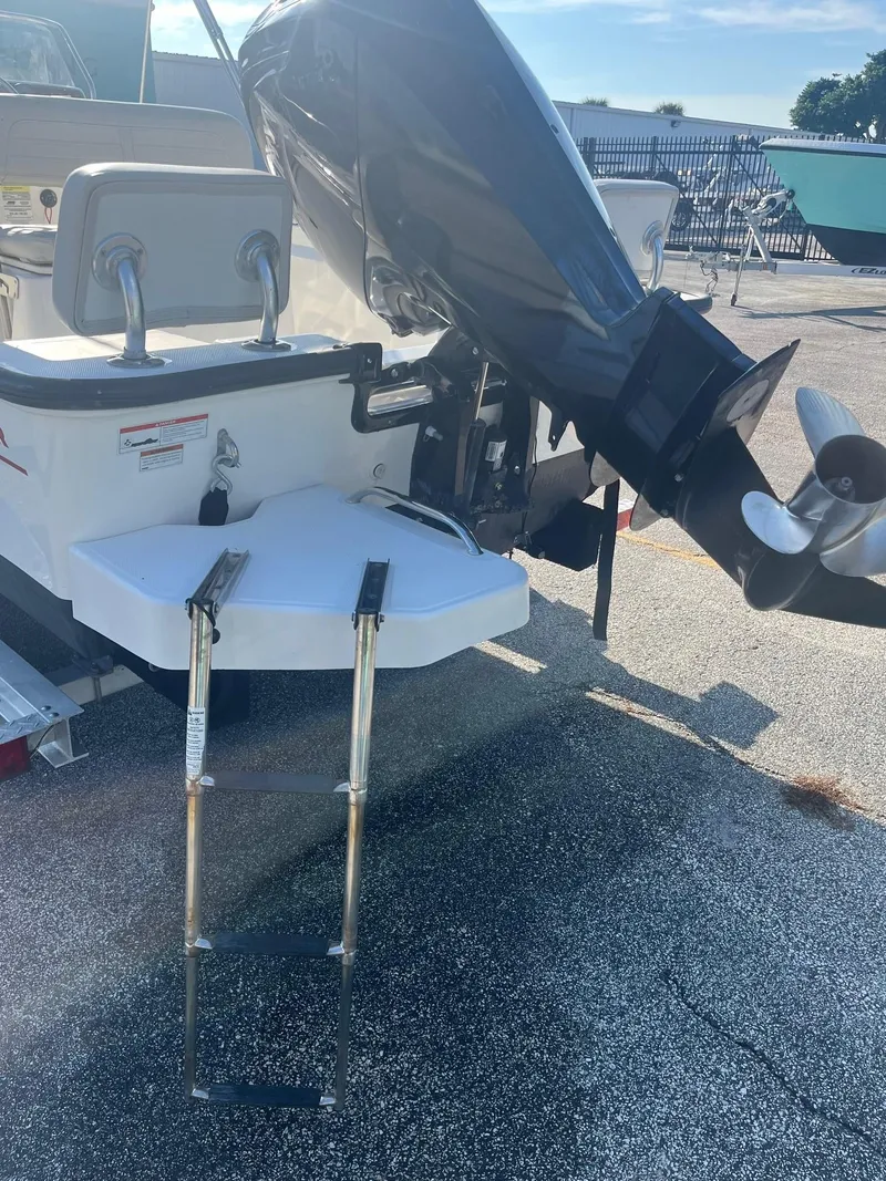 Slide: The Image of 2021 Boston Whaler 170 Montauk boat with outboard motor and swim ladder. - 2