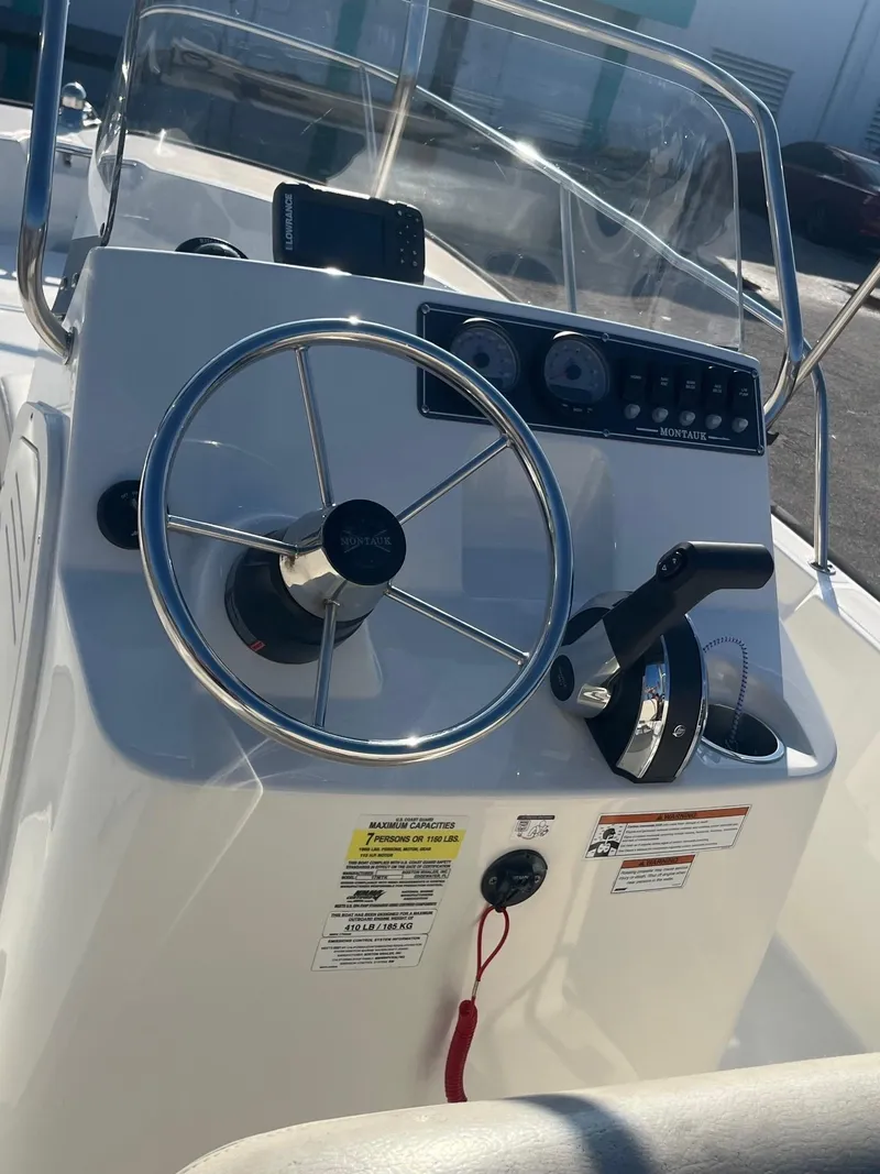 Slide: The Image of 2021 Boston Whaler 170 Montauk boat console with steering wheel and controls. - 5