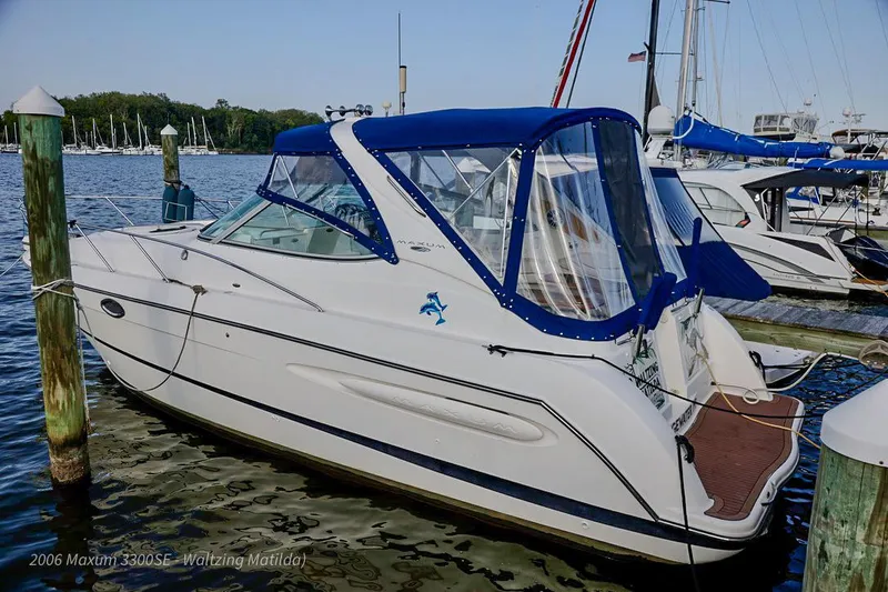 Slide: The Image of 2006 Maxum 3300 SE boat docked in marina with blue canopy. - 0