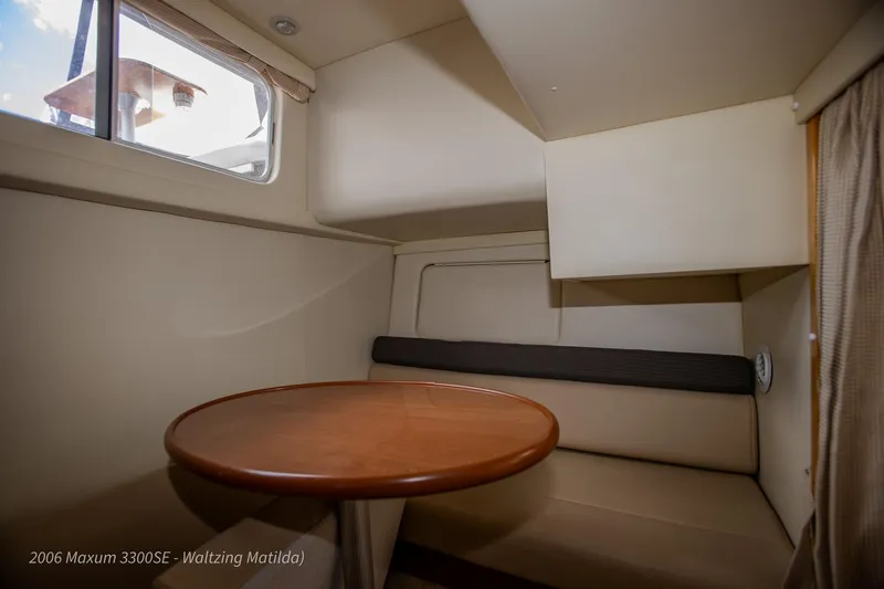 Slide: The Image of Interior of 2006 Maxum 3300 SE boat with cozy seating and round table. - 35