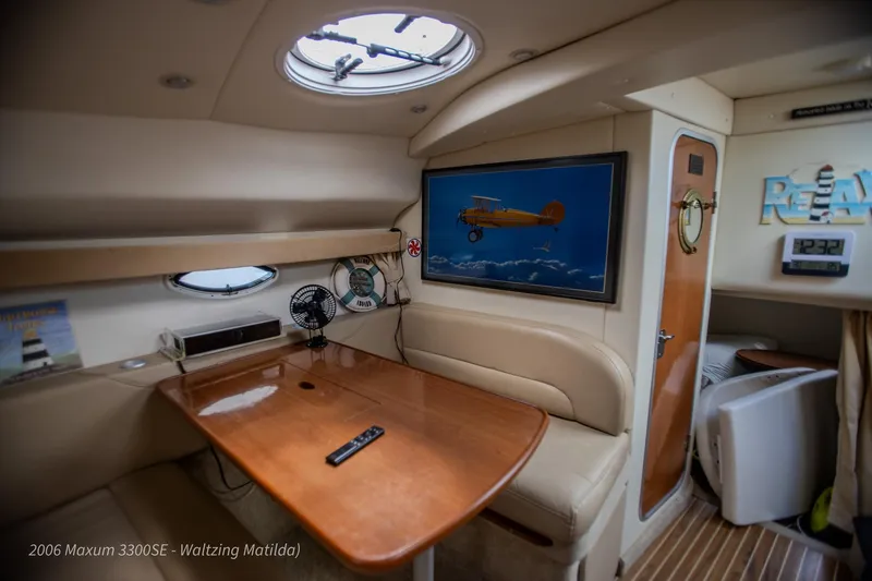 Slide: The Image of Interior of 2006 Maxum 3300 SE yacht with cozy seating and wall art. - 36