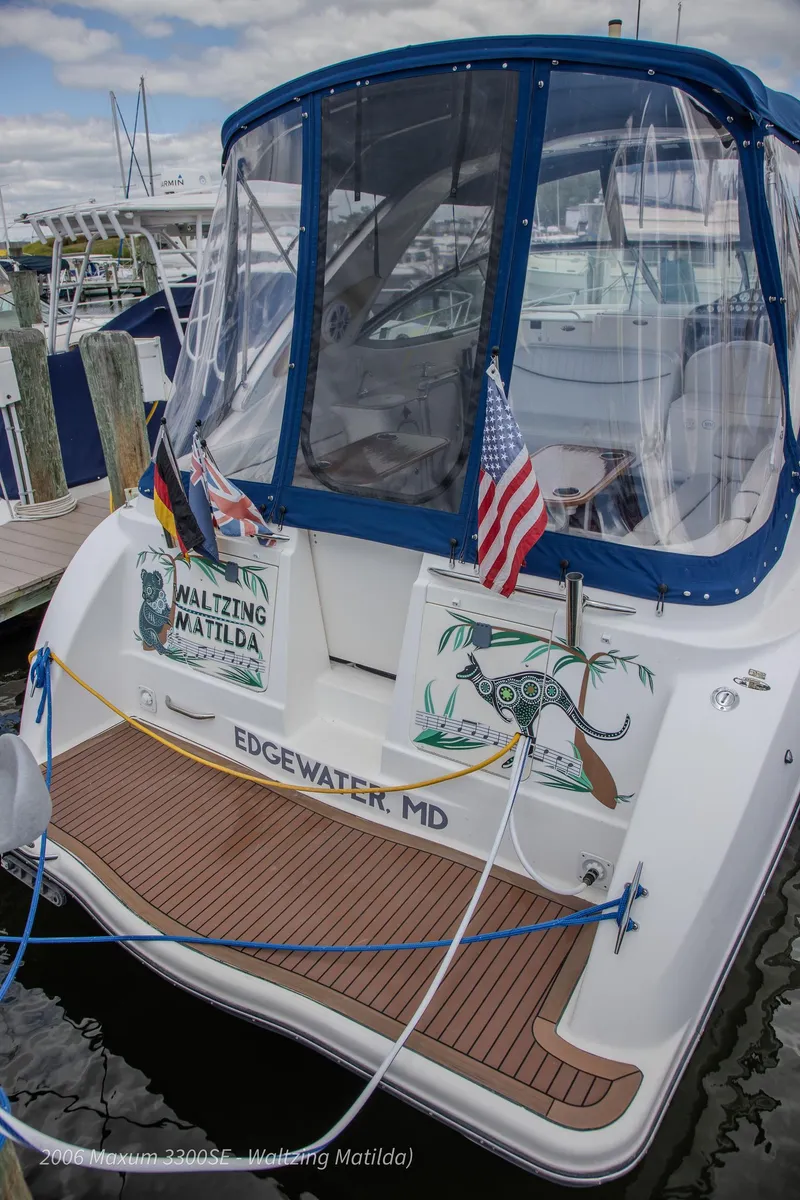 Slide: The Image of 2006 Maxum 3300 SE boat docked, featuring flags and "Waltzing Matilda" signage. - 39