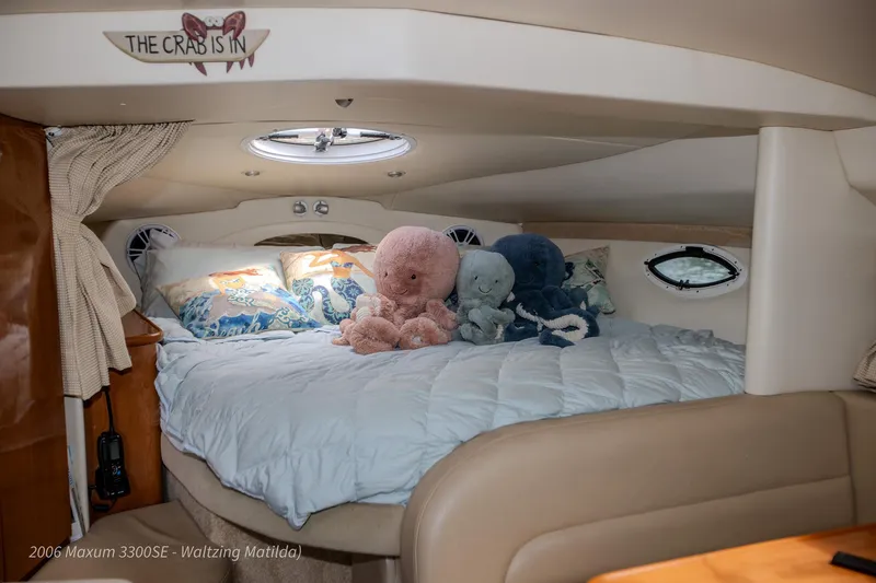 Slide: The Image of Cozy cabin interior of 2006 Maxum 3300 SE with plush toys on bed. - 4