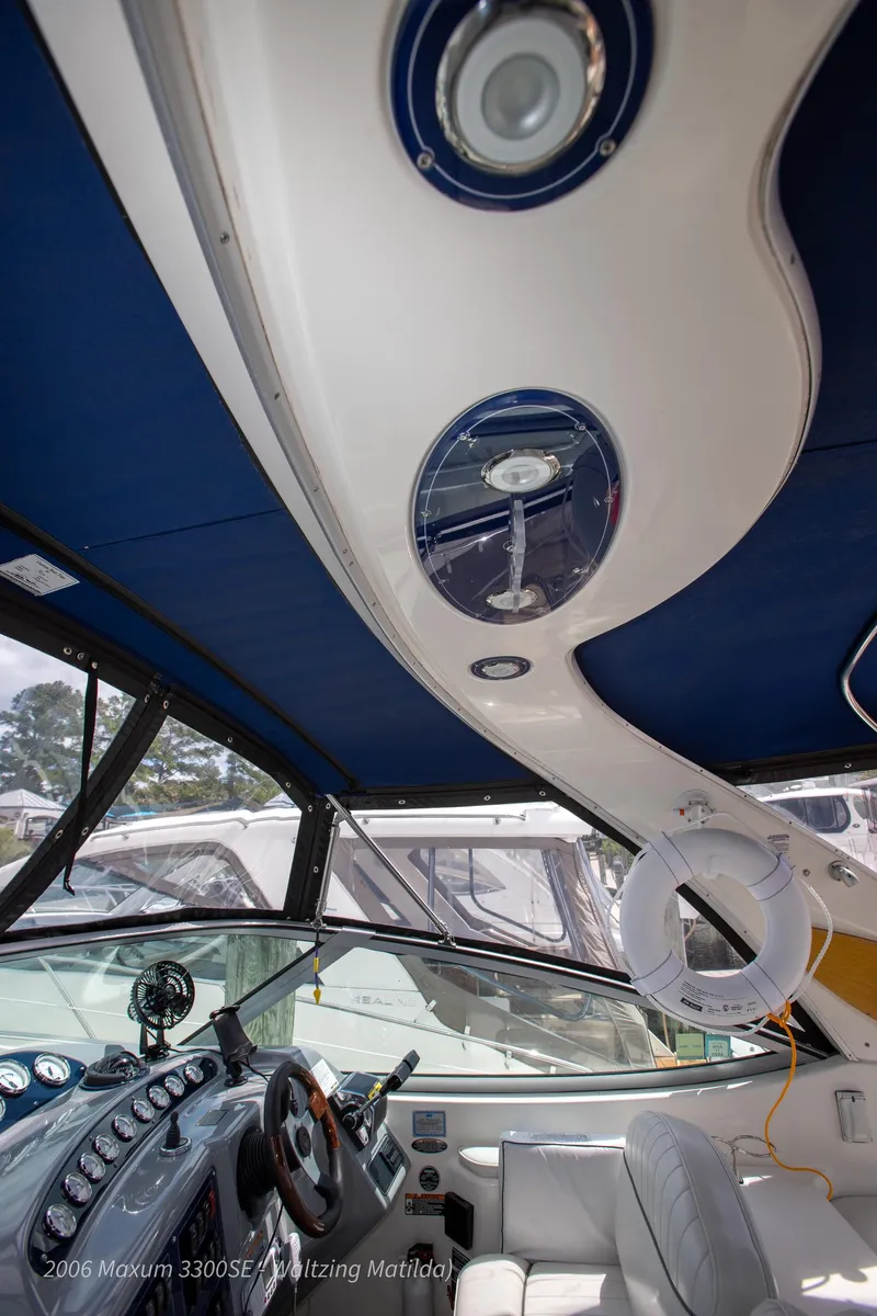 Slide: The Image of Interior view of 2006 Maxum 3300 SE yacht cockpit with steering wheel and seating. - 41