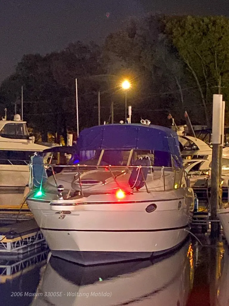 Slide: The Image of 2006 Maxum 3300 SE boat docked at night with lights on. - 43