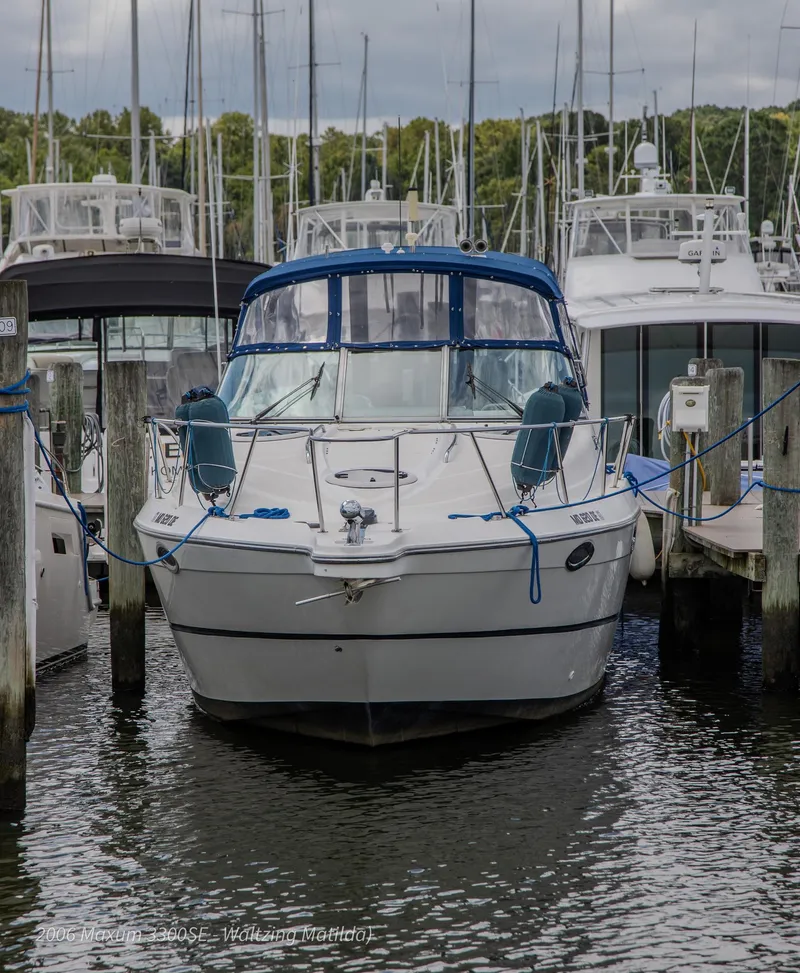 Slide: The Image of 2006 Maxum 3300 SE boat docked at marina with blue canopy. - 9