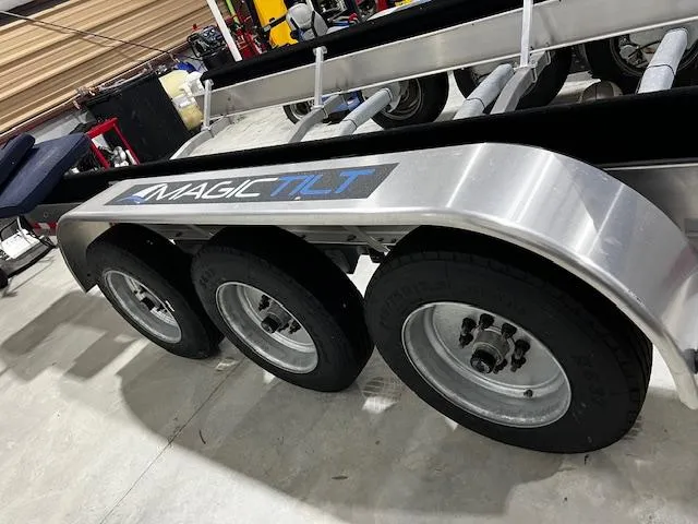 Slide: The Image of Magic Tilt trailer for 2023 Grady-White Freedom 335 boat, featuring triple axles. - 37