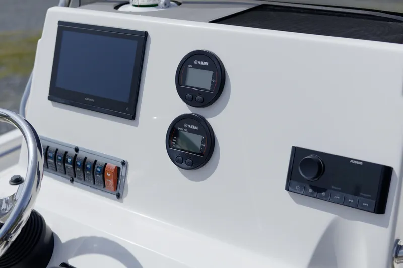 Slide: The Image of 2025 Key West 189 FS boat dashboard with Garmin display and Yamaha gauges. - 10