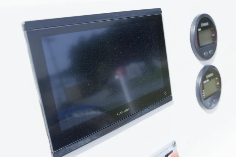 Slide: The Image of Garmin display and gauges on 2025 Key West 189 FS boat dashboard. - 12