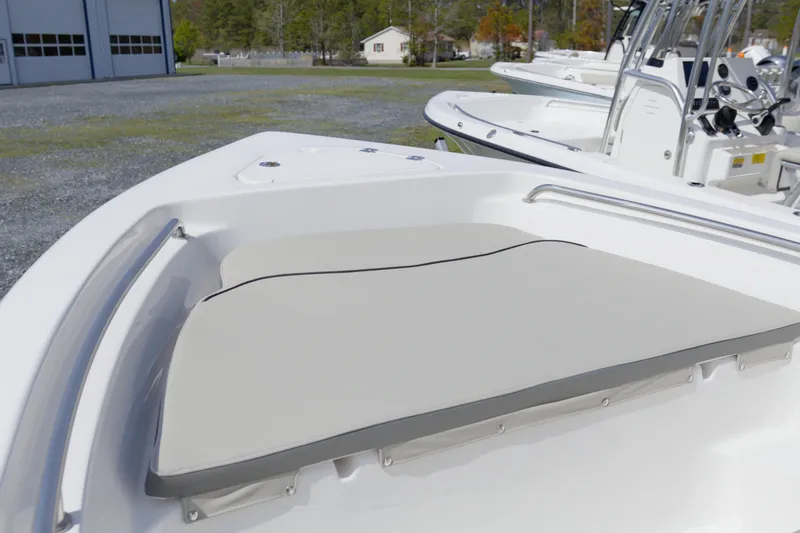Slide: The Image of 2025 Key West 189 FS boat with cushioned seating in a marina setting. - 14