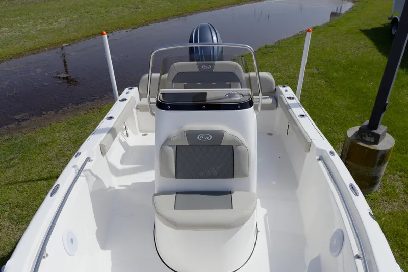 Slide: The Image of 2025 Key West 189 FS boat with sleek design, white interior, and modern seating. - 15
