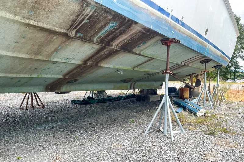 Slide: The Image of 1978 Bertram 46 Convertible boat on stands, showing hull and supports. - 17