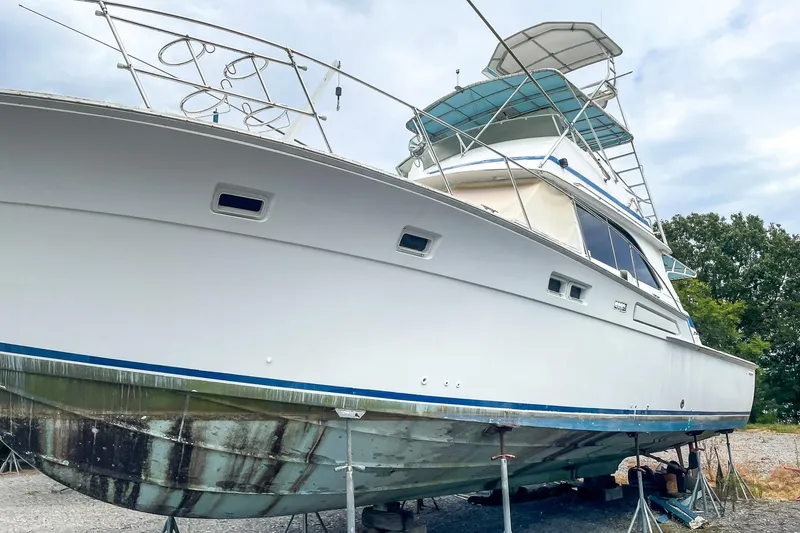 Slide: The Image of 1978 Bertram 46 Convertible yacht on dry dock, showcasing hull and structure. - 18