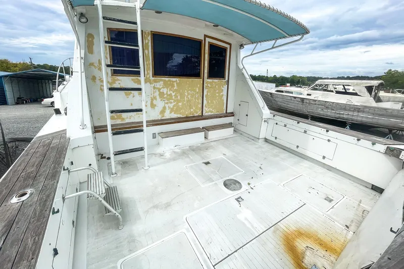 Slide: The Image of 1978 Bertram 46 Convertible boat deck with weathered paint and spacious layout. - 22