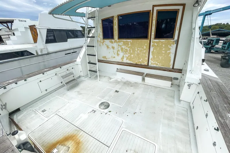 Slide: The Image of 1978 Bertram 46 Convertible boat deck with weathered paint and spacious layout. - 24