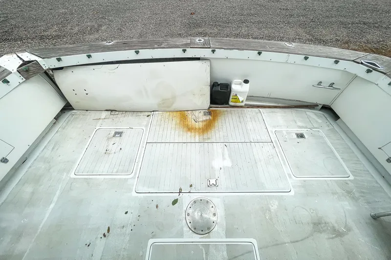 Slide: The Image of 1978 Bertram 46 Convertible boat deck with storage compartments and rust stain. - 28