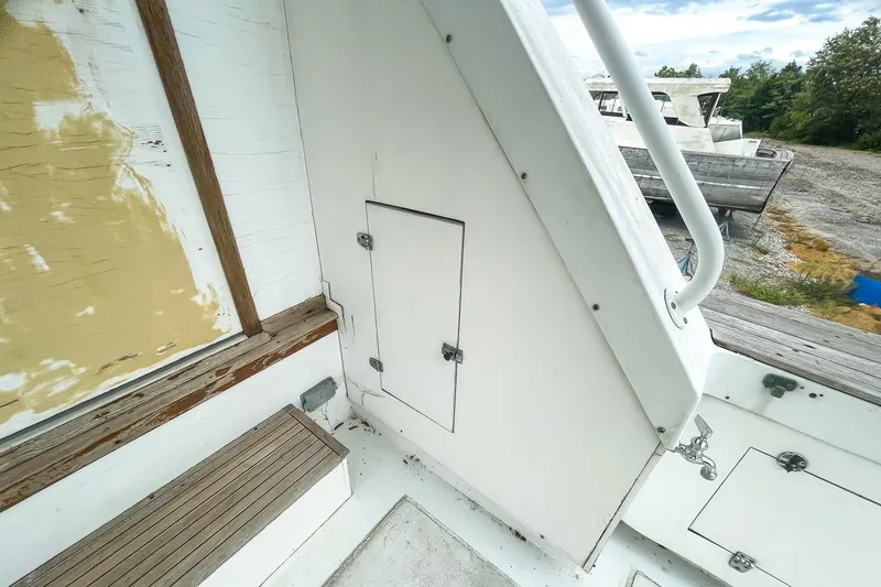 Slide: The Image of 1978 Bertram 46 Convertible boat interior with white panels and wooden accents. - 33