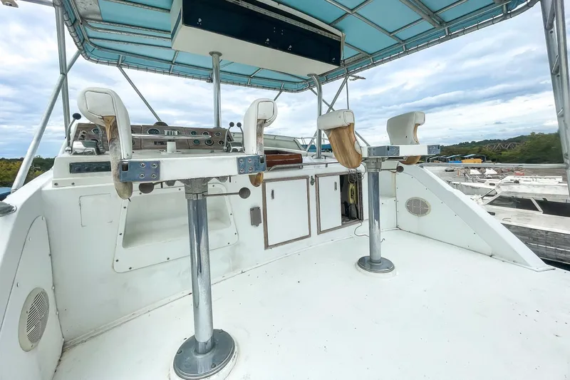 Slide: The Image of 1978 Bertram 46 Convertible boat deck with seating and controls under a canopy. - 37