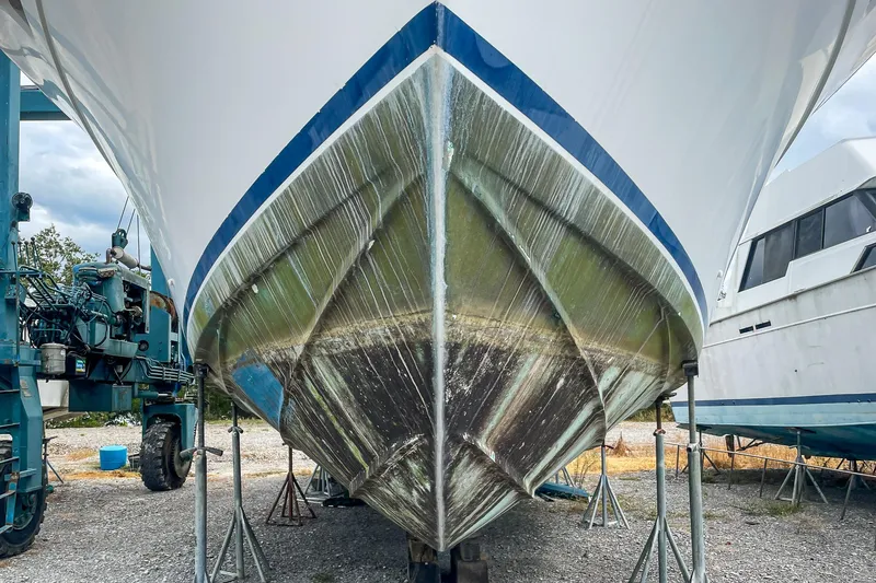 Slide: The Image of 1978 Bertram 46 Convertible boat hull on dry dock, showcasing its sleek design. - 4