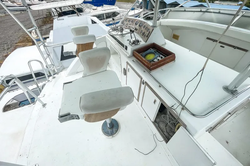 Slide: The Image of 1978 Bertram 46 Convertible yacht cockpit with helm chairs and control panel. - 40