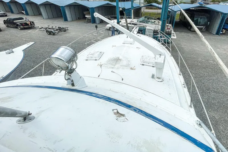 Slide: The Image of 1978 Bertram 46 Convertible boat on land, view of deck and storage area. - 43