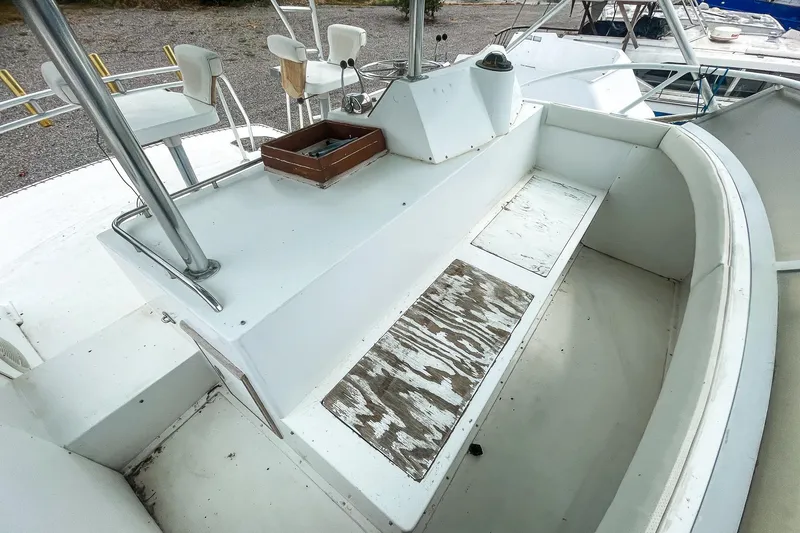 Slide: The Image of 1978 Bertram 46 Convertible boat interior with seating and helm area. - 44