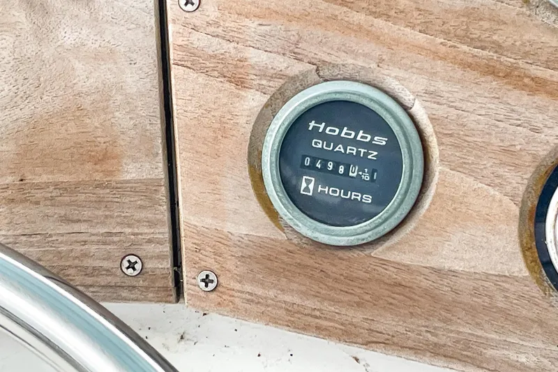 Slide: The Image of Hobbs quartz hour meter on 1978 Bertram 46 Convertible boat dashboard. - 49