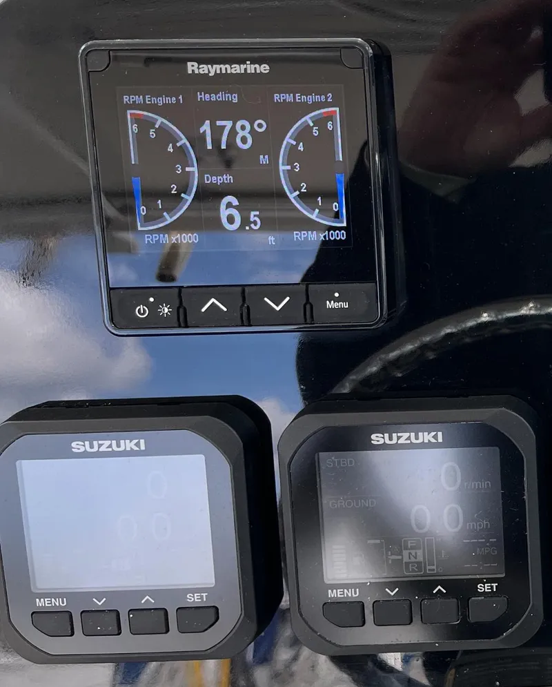 Slide: The Image of Boat dashboard with Raymarine and Suzuki displays on a 2005 Pursuit 3070 WA EXPRESS. - 10