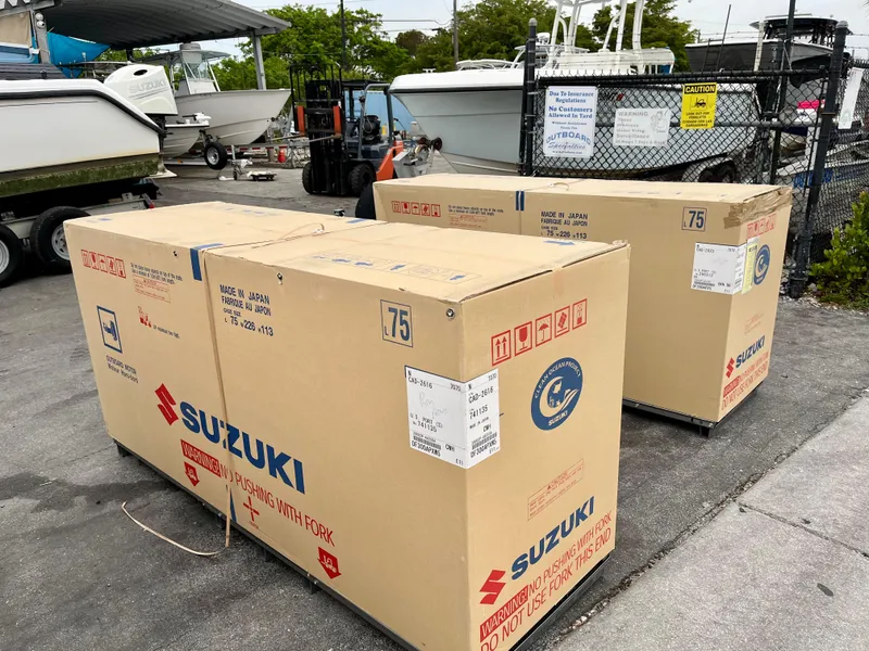 Slide: The Image of Boxes of Suzuki outboard motors near 2005 Pursuit 3070 WA EXPRESS boat. - 15