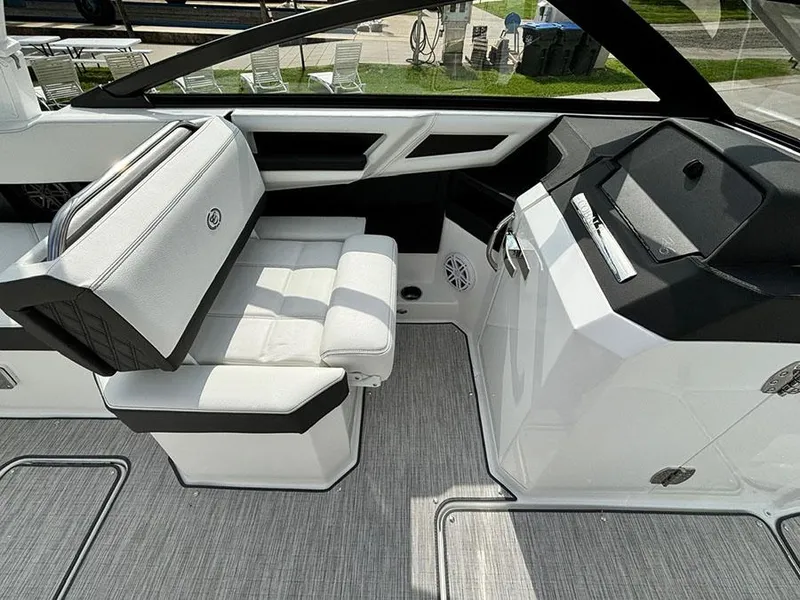 Slide: The Image of 2025 Cobalt R6 Outboard interior with white seating and modern dashboard design. - 21