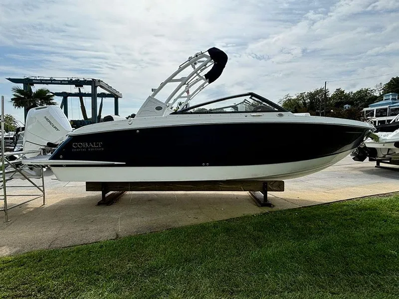 Slide: The Image of 2025 Cobalt R6 Outboard boat displayed outdoors on a sunny day. - 5