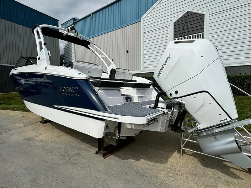 Slide: The Image of 2025 Cobalt R6 Outboard boat with Mercury engine, parked outdoors. - 7