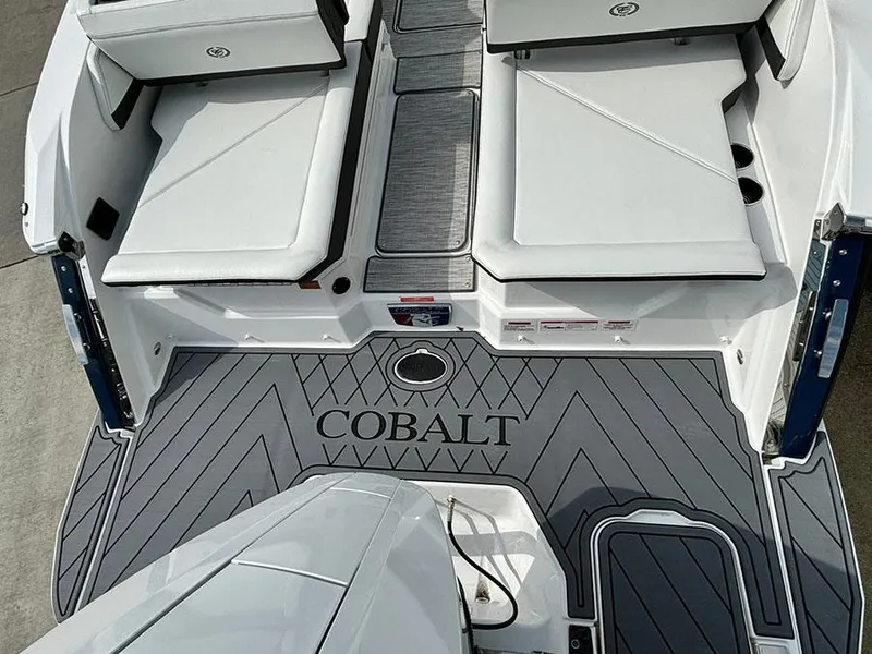 Slide: The Image of 2025 Cobalt R6 Outboard boat deck with cushioned seating and stylish flooring. - 9