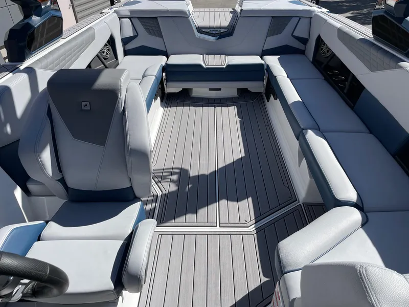Slide: The Image of 2023 Nautique Super Air Nautique S25 interior with spacious seating and modern design. - 12
