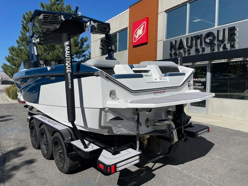 Slide: The Image of 2023 Nautique Super Air Nautique S25 boat on trailer outside dealership. - 3