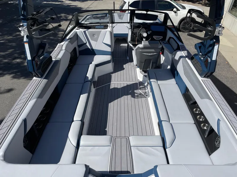 Slide: The Image of 2023 Nautique Super Air Nautique S25 boat interior with spacious seating and modern design. - 5