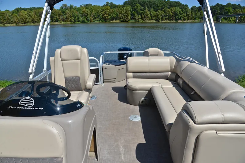 Slide: The Image of 2021 Sun Tracker Fishin Barge 20 DLX pontoon boat on a serene lake. - 22